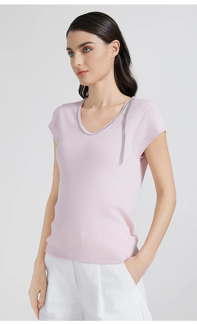 Model wearing Prim wool-silk top with rhinestone detail, hand resting casually in pants pocket. From Borcelleclothes.