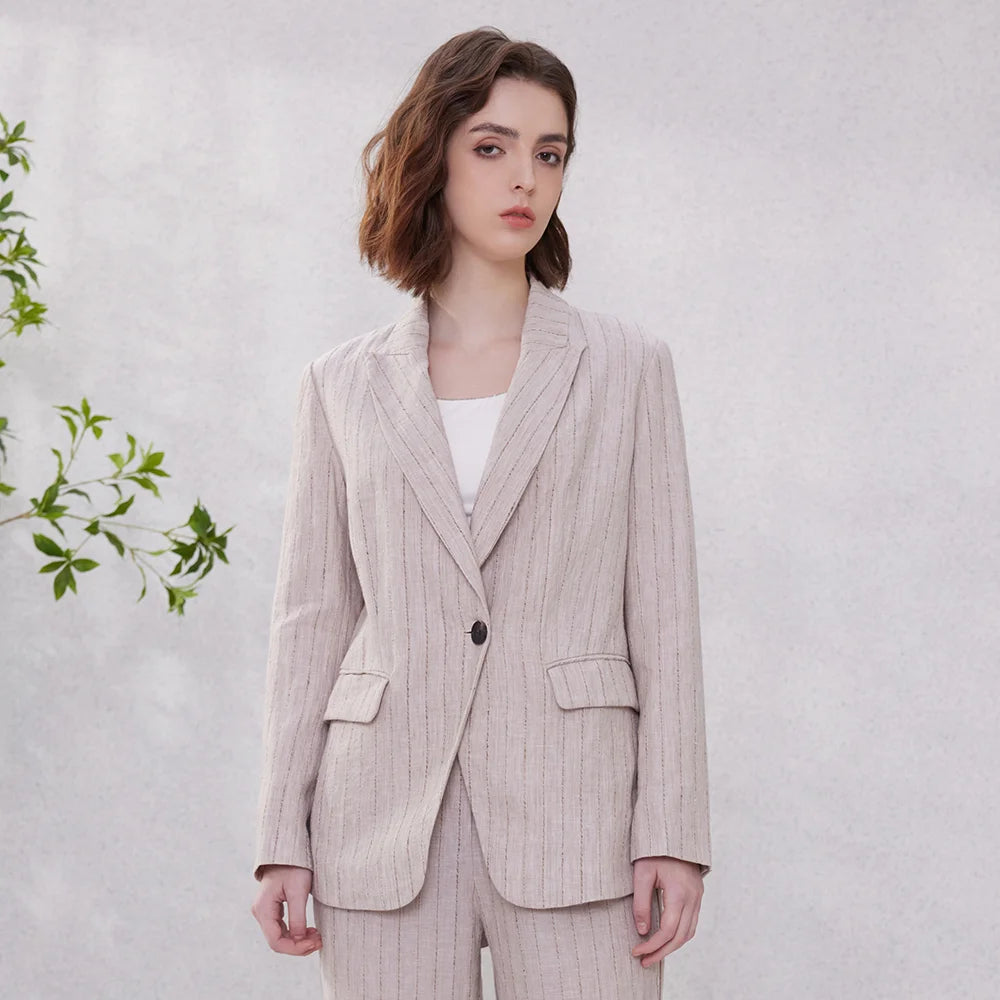 Model wearing women’s woven stripes linen blazer in Pink Swan shade, standing with arms straight. From Borcelleclothes.