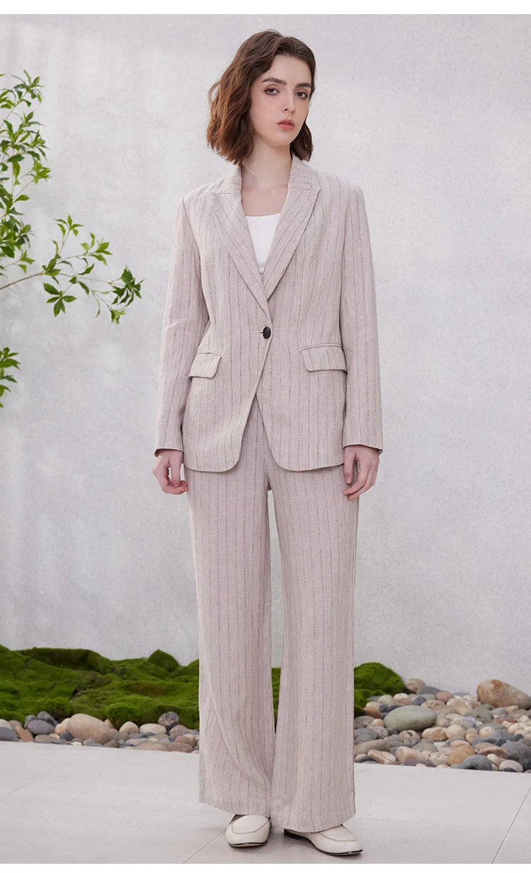 Full-length view of a model wearing a stripes linen blazer in Pink Swan, tailored cut with woven striped fabric. From Borcelleclothes.
