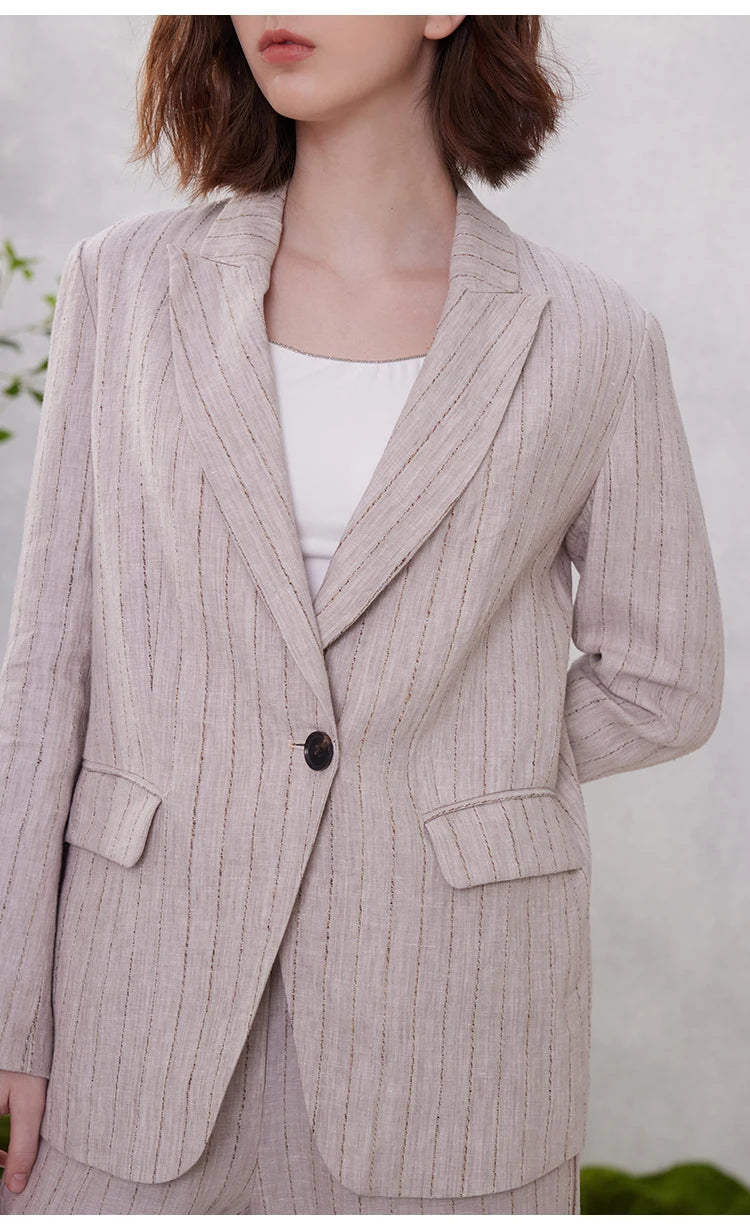 Model in Pink Swan woven stripes linen blazer with one hand placed behind back. From Borcelleclothes.