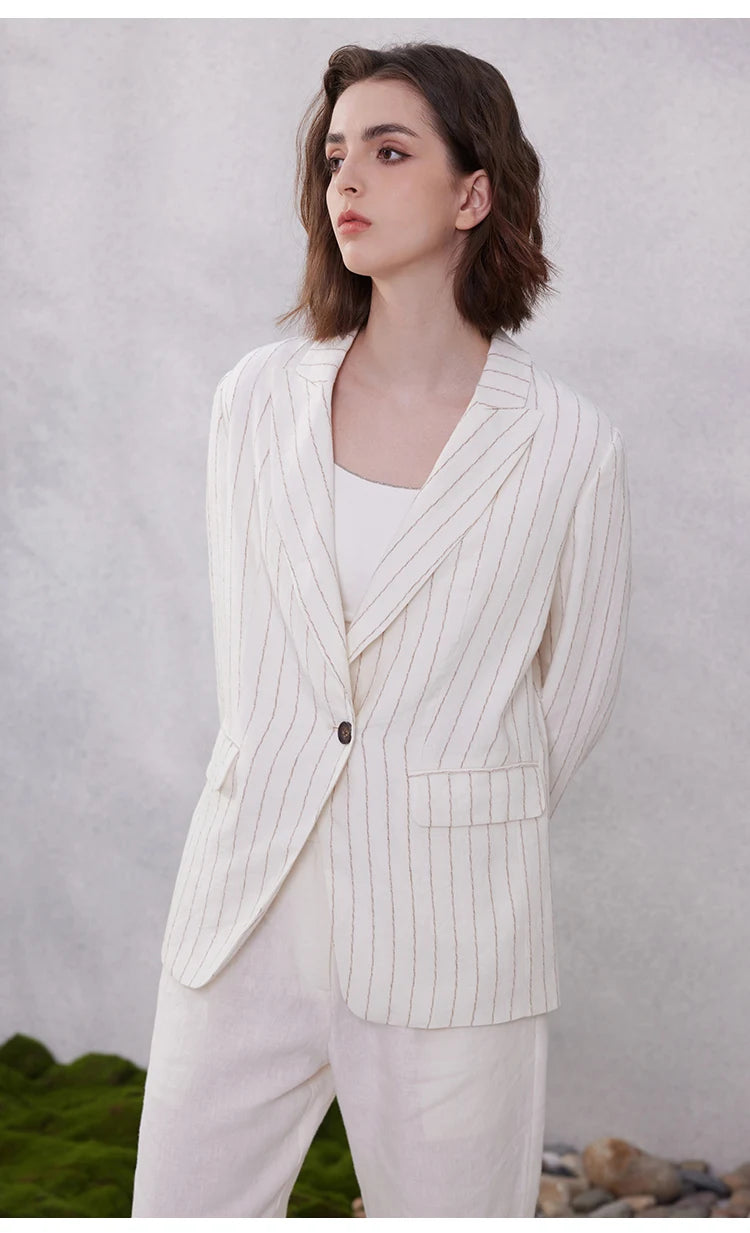 Model in Platinum woven stripes linen blazer looking to the side, showing textured striped fabric. From Borcelleclothes.