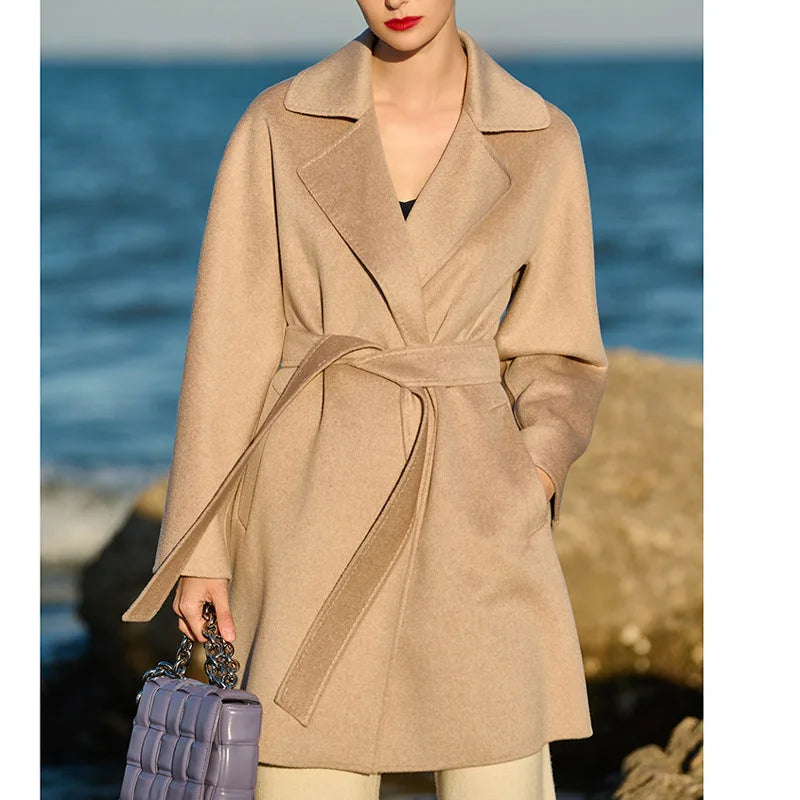 Women's mid-thigh wrap coat in Cameo cashmere with kimono sleeves and notch lapels. From Borcelleclothes.
