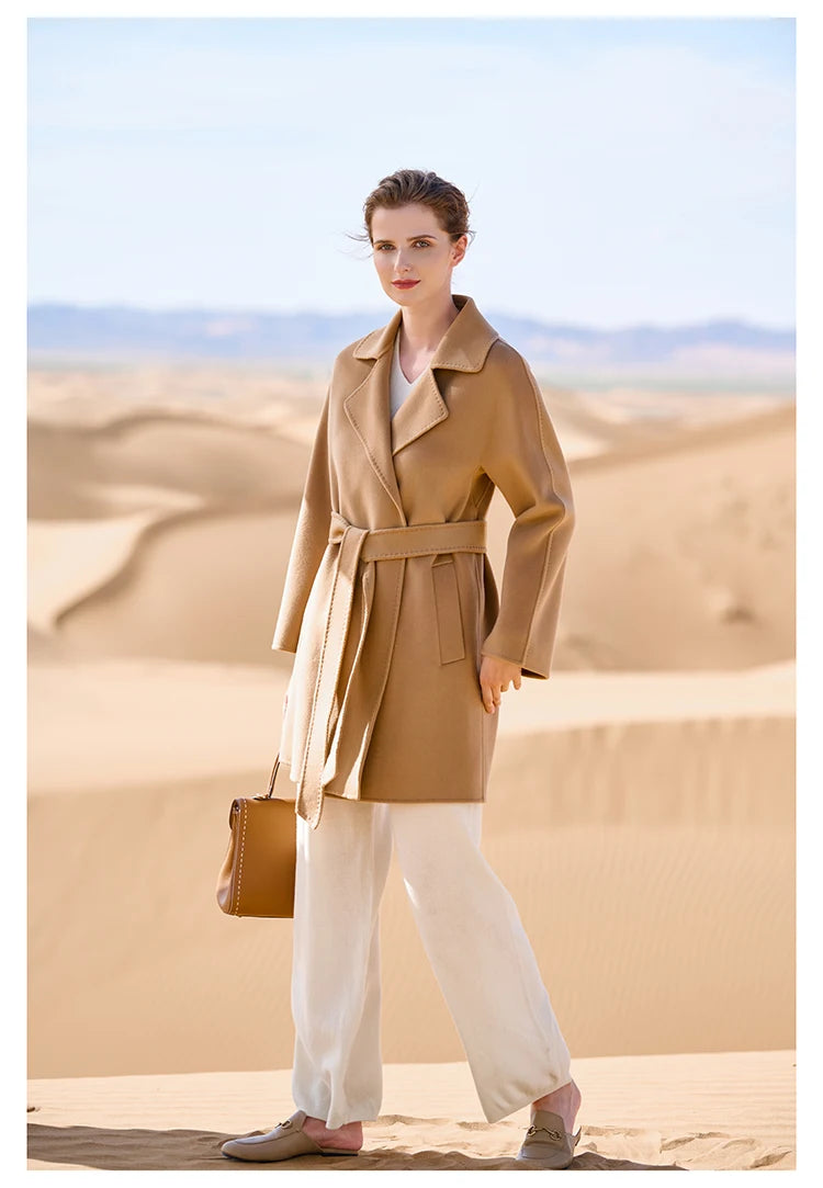 Model wearing a French Beige wrap cashmere coat, turned slightly to the side. From Borcelleclothes.