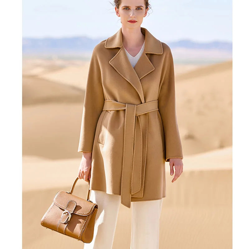 Women's mid-thigh wrap coat in French Beige cashmere with kimono sleeves and notch lapels. From Borcelleclothes.