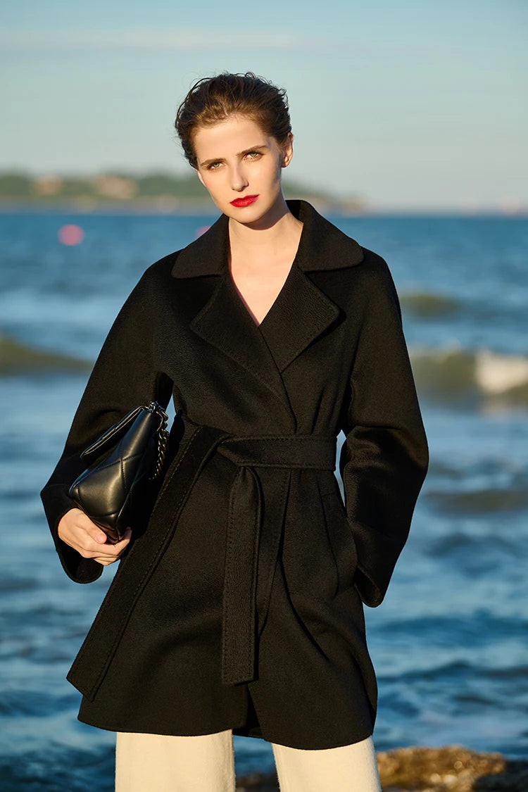 Model wearing an Onyx wrap cashmere coat, hand tucked in pocket. From Borcelleclothes.