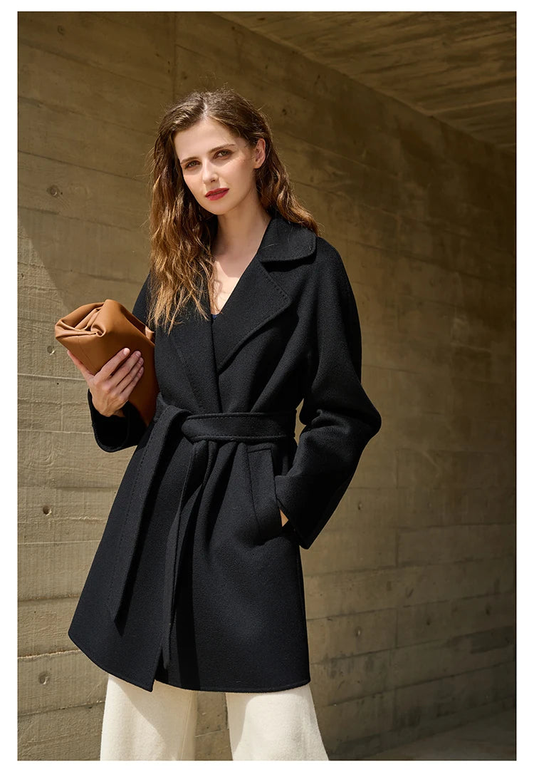 Model wearing an Onyx wrap cashmere coat, turned slightly to the side. From Borcelleclothes.