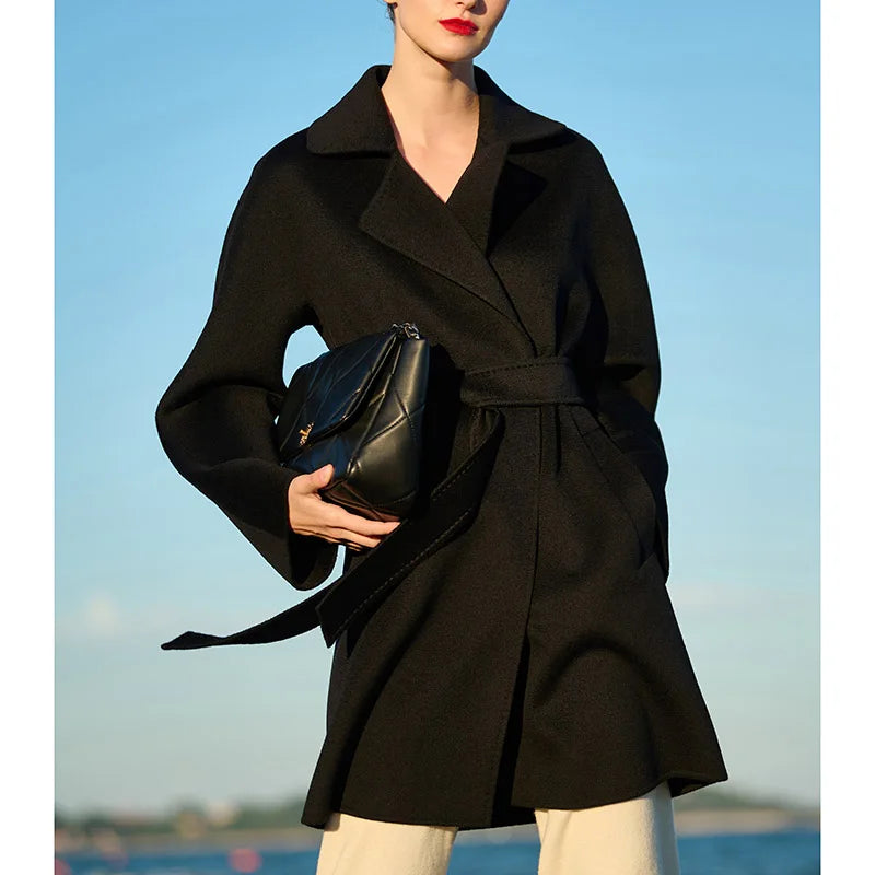Women's mid-thigh wrap coat in Onyx cashmere with kimono sleeves and notch lapels. From Borcelleclothes.