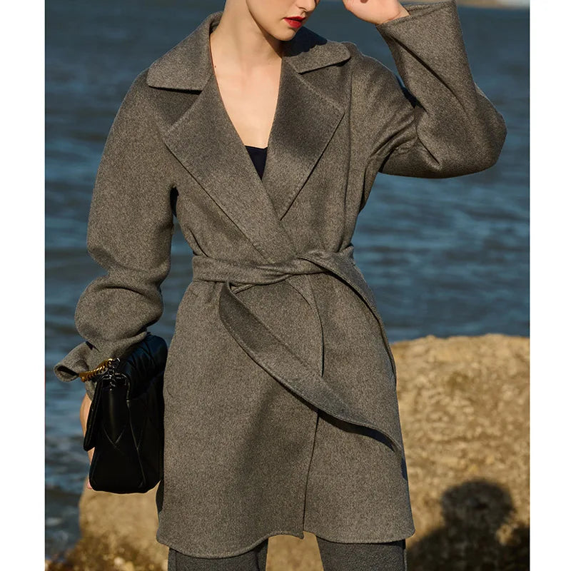 Women's mid-thigh wrap coat in Sandstone cashmere with kimono sleeves and notch lapels. From Borcelleclothes.