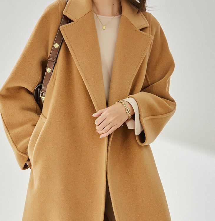 The upper part of the Women's Wrap Coat Redefined in Brown Sugar, highlighting its structured square gussets and modern tailoring. From Borcelleclothes.