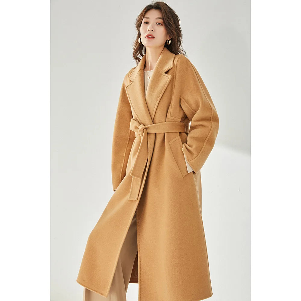 Women's Wrap Coat Redefined in Brown Sugar—crafted from a luxurious blend of Merino wool and cashmere. Featuring square gussets for a structured silhouette, notch lapels, a single-welt pocket design, and an adjustable belt, this mid-calf wrap coat blends modern tailoring with timeless elegance. From Borcelleclothes.