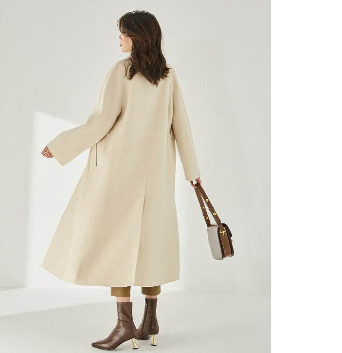 Back of the Women's Wrap Coat Redefined in Soft Amber, showcasing its structured square gussets and flowing mid-calf silhouette. From Borcelleclothes.