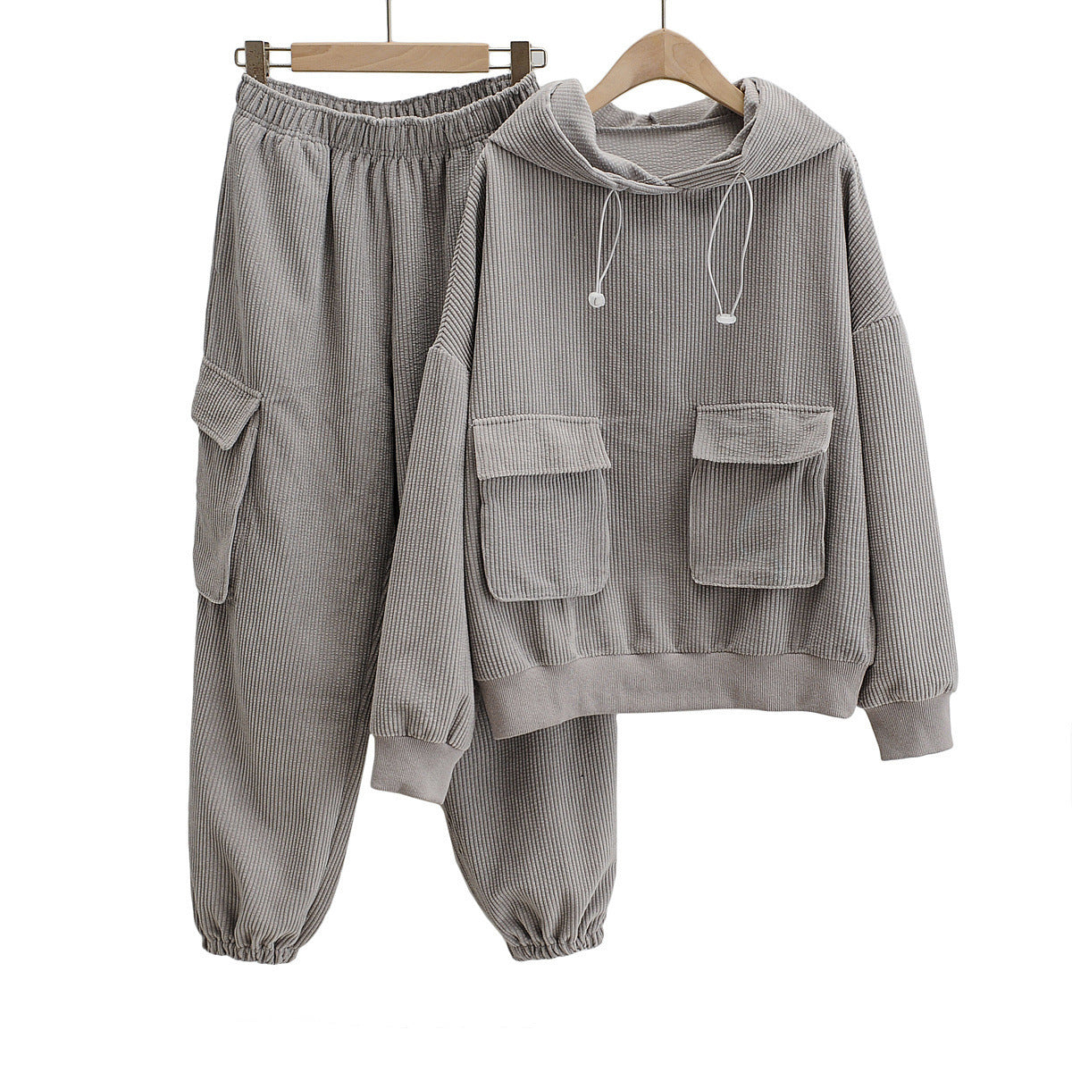 Women's Wide Wale Corduroy Sweatshirt and Sweatpants Set in Natural Grey, designed with cargo flap pockets, a drawstring hood, and elastic ribbed cuffs and waistband for a relaxed, stylish fit. From Borcelleclothes.