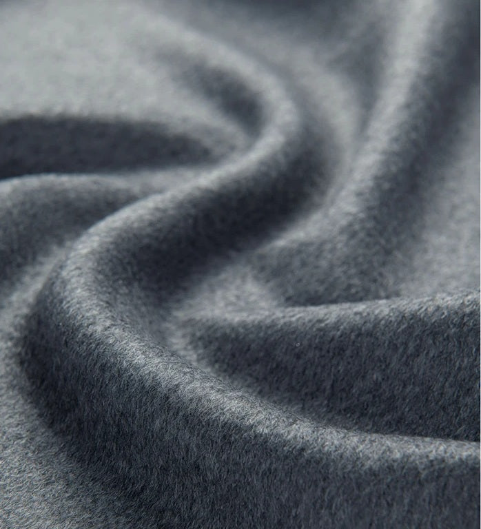 Bright Grey cashmere-wool fabric, highlighting its soft drape and smooth texture. From Borcelleclothes.