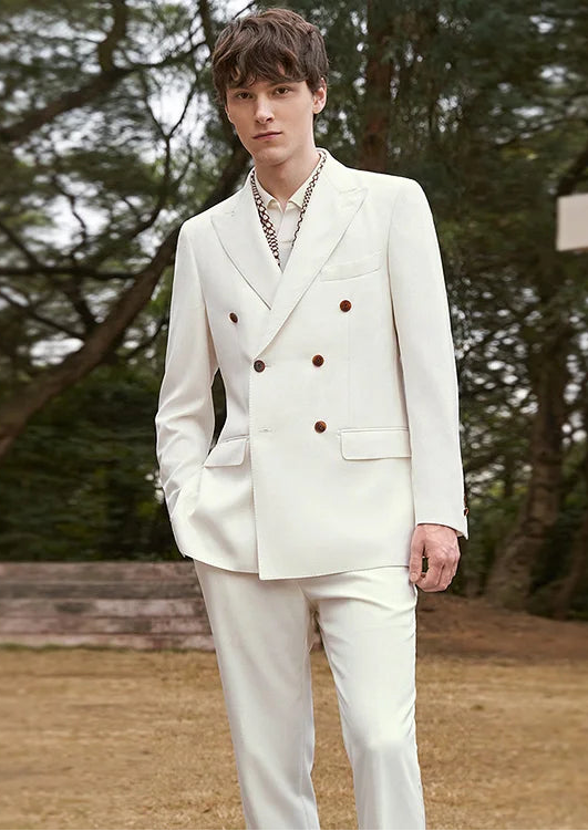 Model wearing the Men's Alabaster Merino Wool Suit with one hand casually placed in the pants pocket, showcasing its tailored fit. From Borcelleclothe.