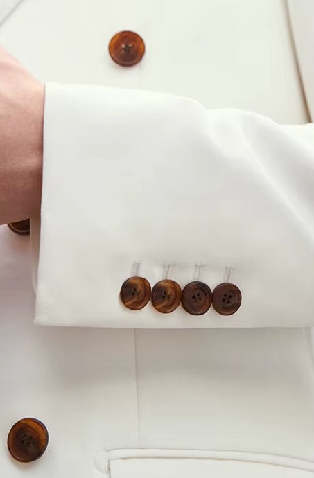 The Men's Alabaster Merino Wool Suit's sleeve placket with four horn-brown buttons, highlighting craftsmanship. From Borcelleclothes.