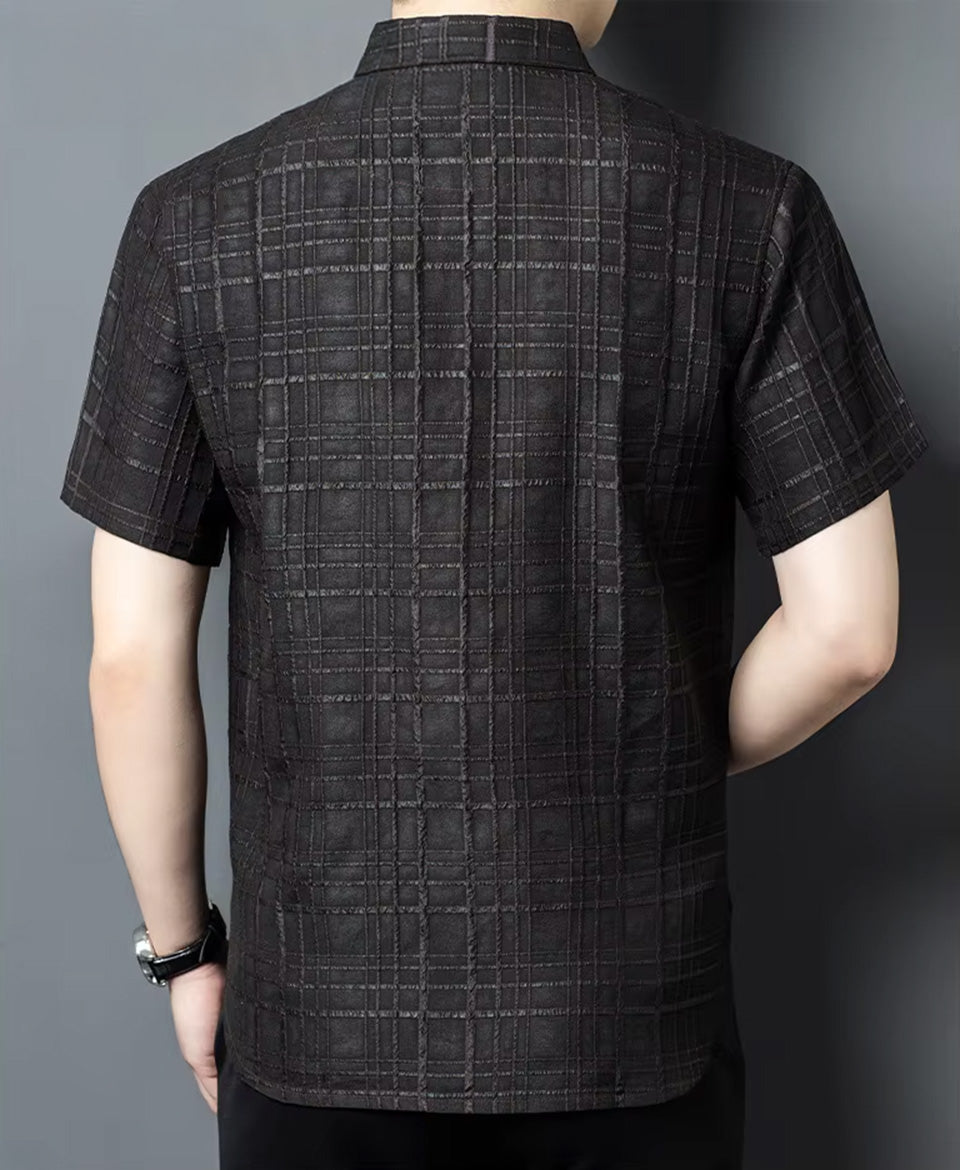 Rear view of a model wearing the checkered dark graphite Xiangyunsha silk shirt, demonstrating the back fit and drape — From Borcelleclothes.