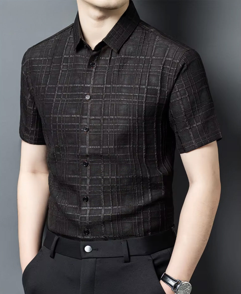 A men's short-sleeve Xiangyunsha silk shirt in Checked Nocturne color, presented on a model turned slightly to the side — From Borcelleclothes.