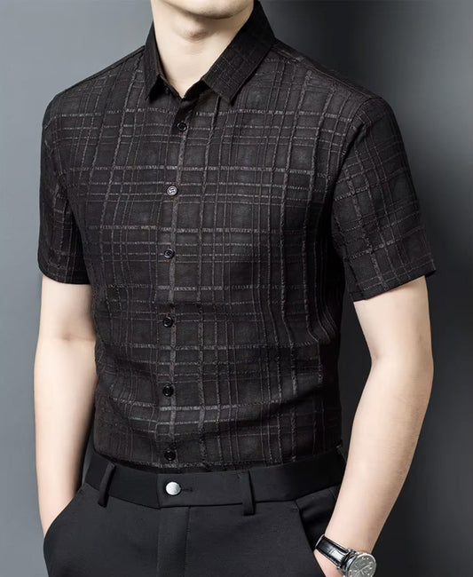 A men's short-sleeve Xiangyunsha silk shirt in Checked Nocturne color, presented on a model turned slightly to the side — From Borcelleclothes.