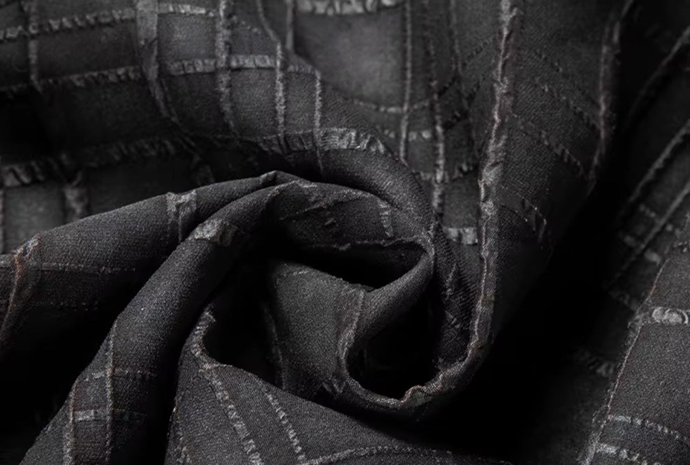 Close-up of the monochrome dobby check texture on spiral-folded Mulberry silk fabric in Checked Nocturne color — From Borcelleclothes.