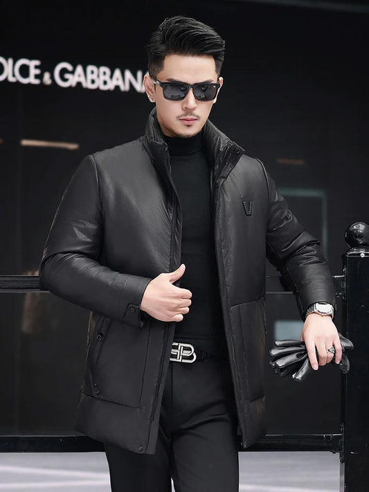 Men’s cowhide down jacket in Onyx, unzipped, model leaning on railing — From Borcelleclothes.