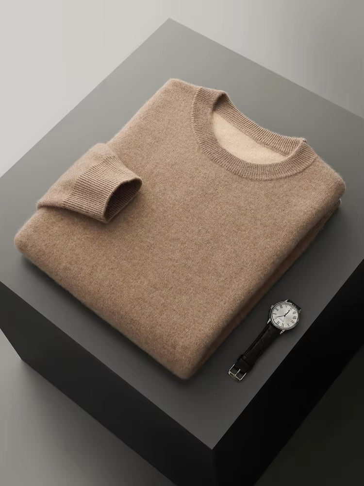 Neatly folded men’s double-knit fine wool sweater in Mountain Road warm taupe placed on a display cube with a watch, showing the contrast inner layer — From Borcelleclothes.