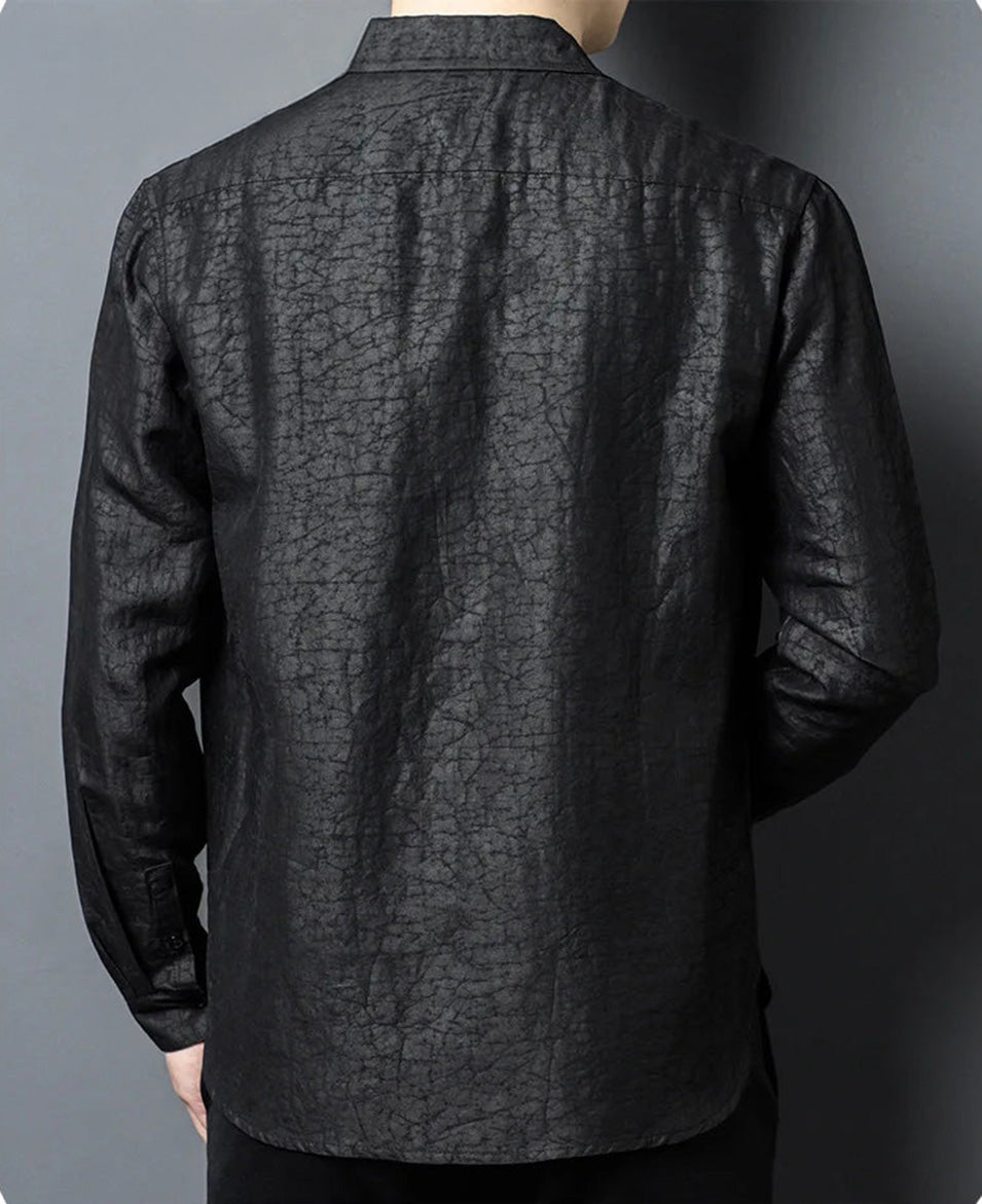 The back view of a man standing still in the Men's Gambiered Guangdong Silk Shirt, demonstrating the sharp tailored fit, seamless shoulder line, and powerful silhouette of the Obsidian Jaguar silk — From Borcelleclothes.