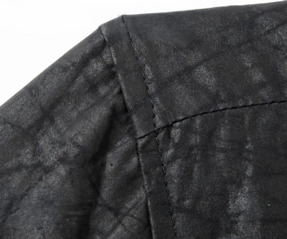 Detail shot of the shirt's shoulder seam, showcasing how the heavy, premium Xiangyunsha silk drapes naturally over a man's frame in the dim light of an office — From Borcelleclothes.