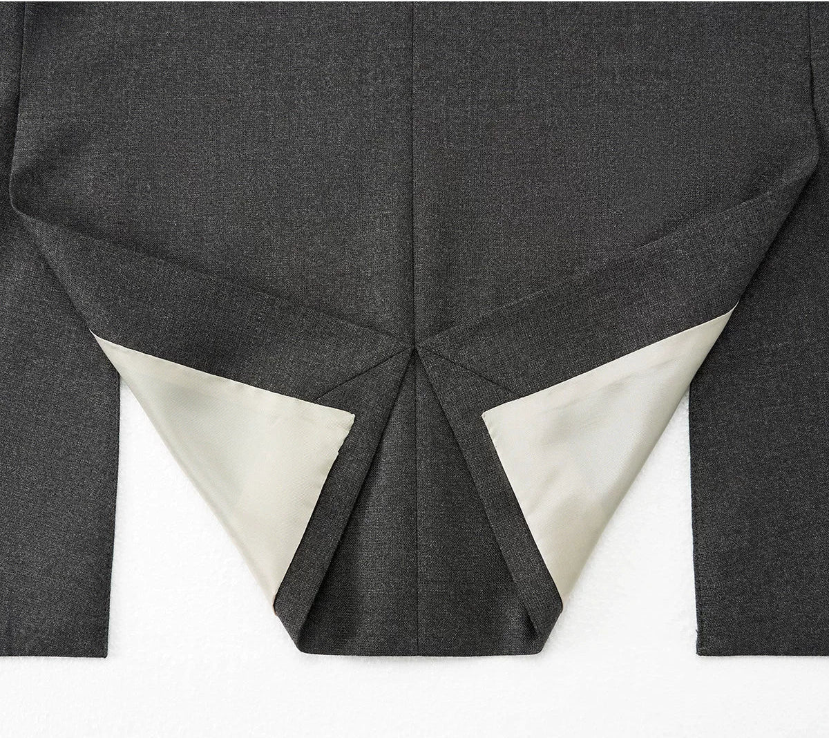 Detailed back view showing the construction, reinforced stitching, and clean finish of the dual side vents — From Borcelleclothes.