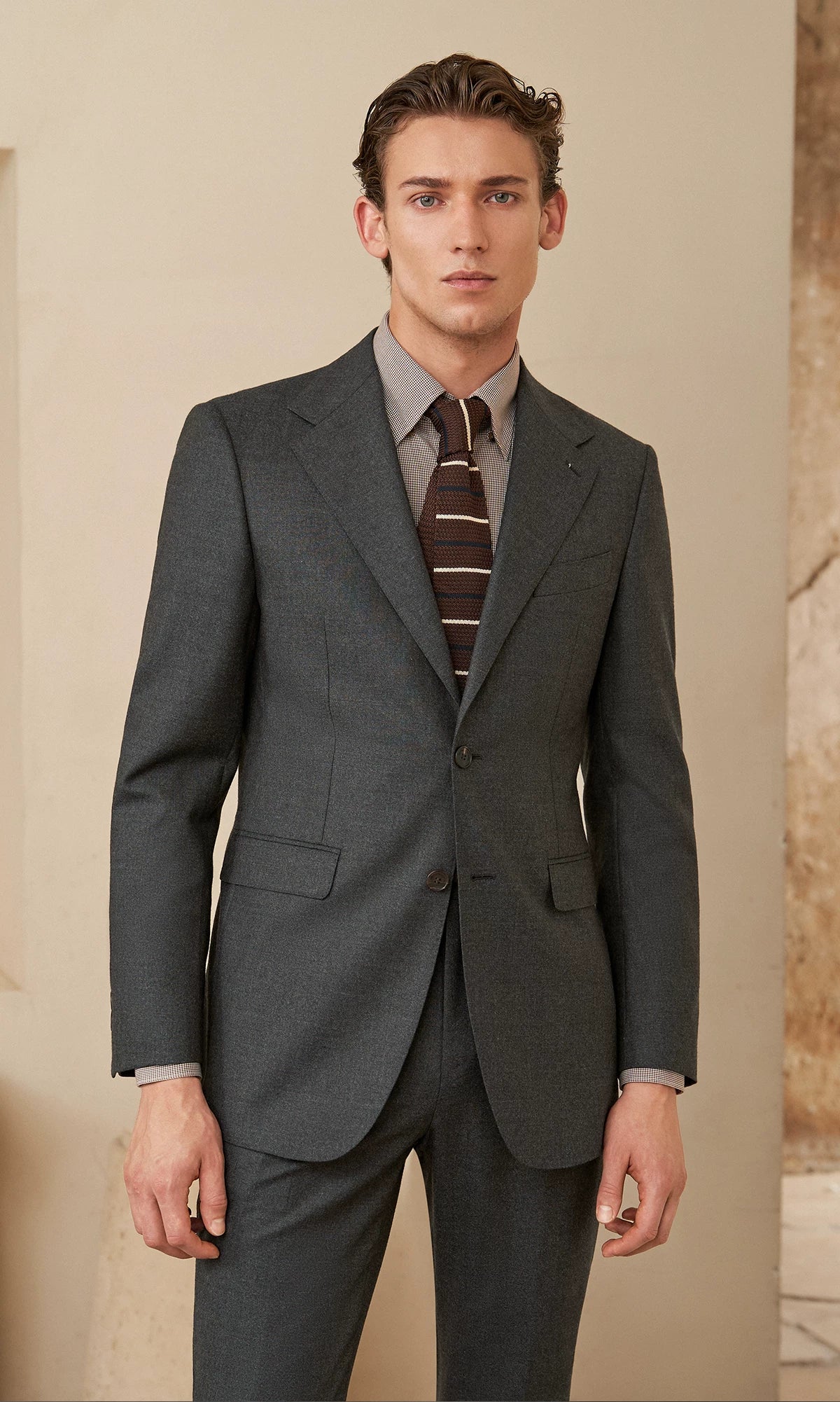 Full-length frontal view of model wearing the Portofino charcoal wool flannel two-piece half-canvas suit — From Borcelleclothes.
