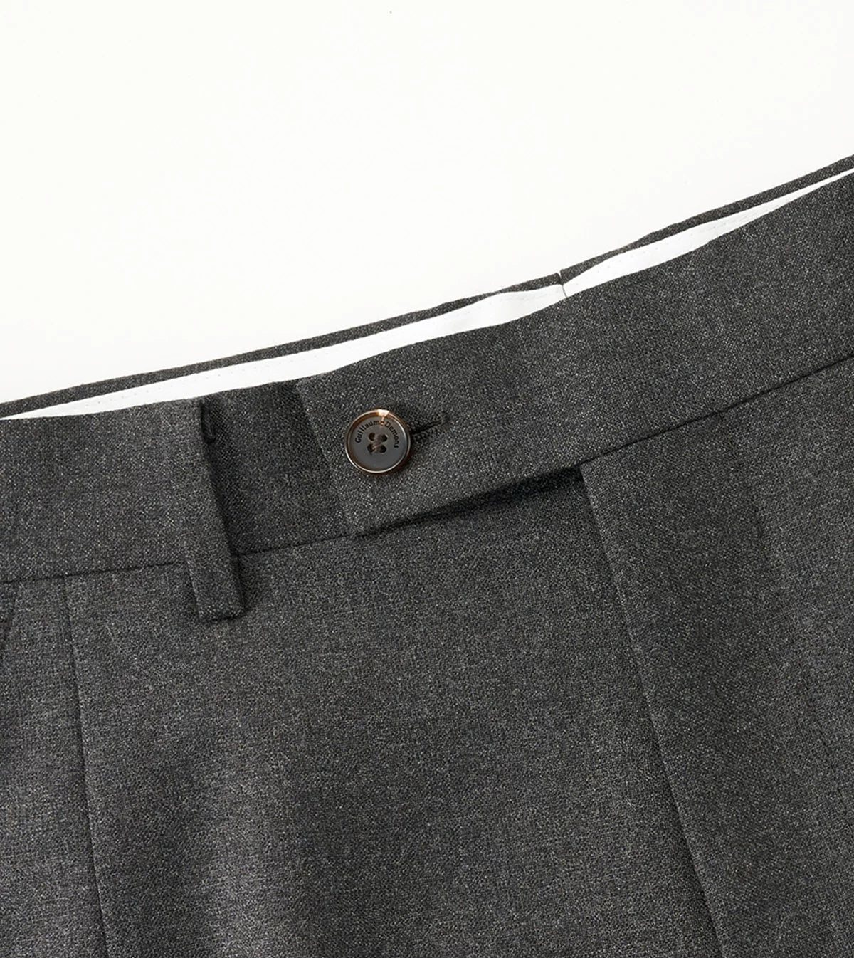 Detailed view of the flat-front trouser waistband featuring a clean tab closure, belt loops, and smooth drape — From Borcelleclothes.