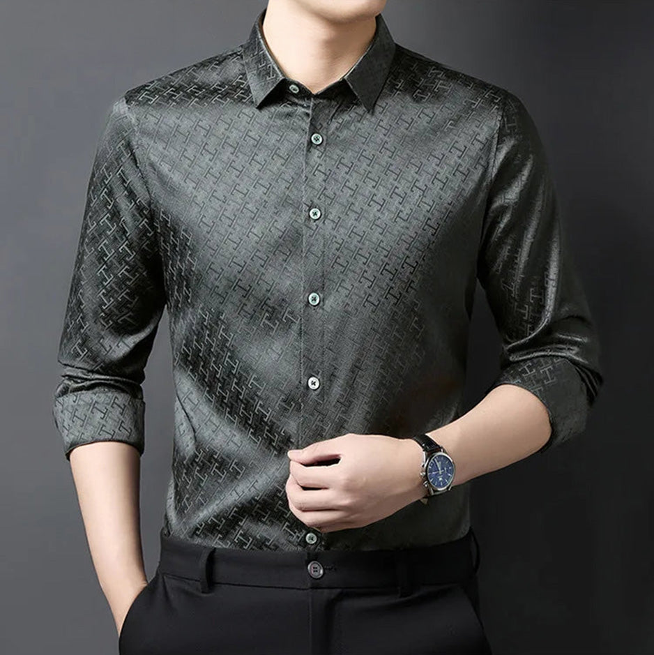 A man adjusting the sharp front placket of his luxury grey silk jacquard shirt, highlighting the geometric design and structured lines — From Borcelleclothes.