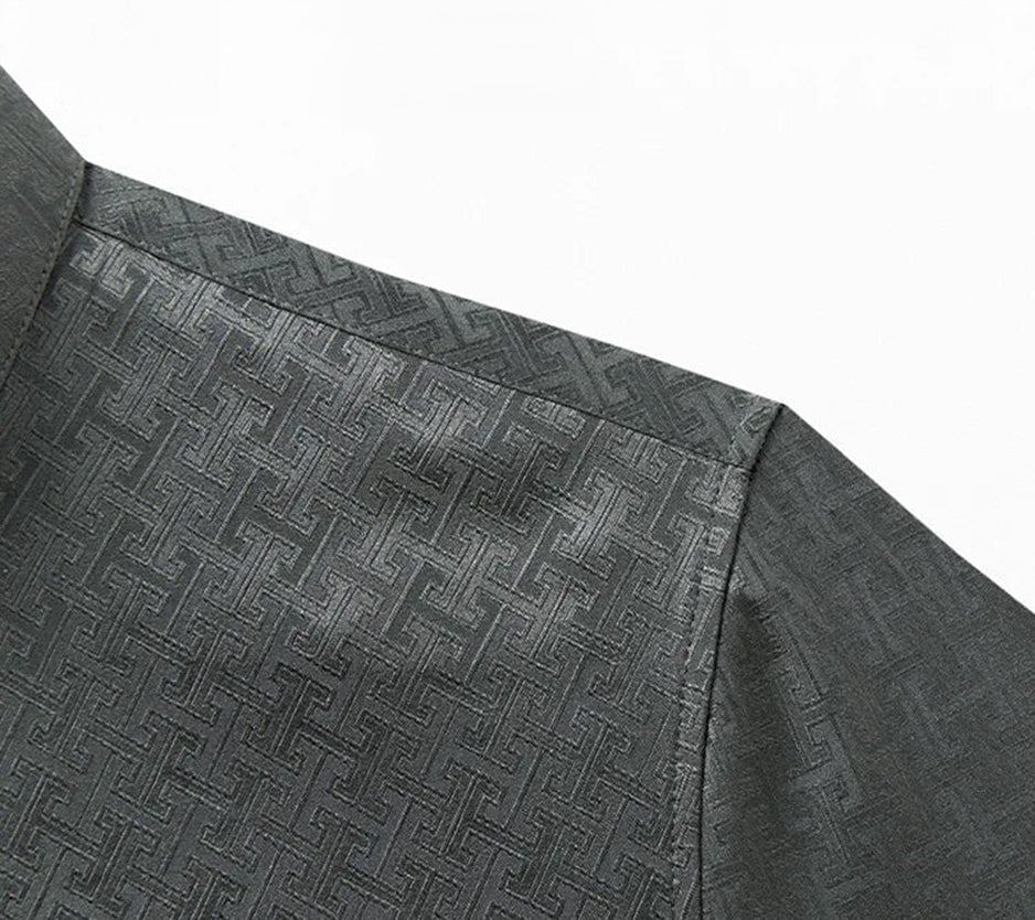 Detailed close-up of the tailored shoulder construction and geometric fabric texture on the grey luxury silk shirt — From Borcelleclothes.