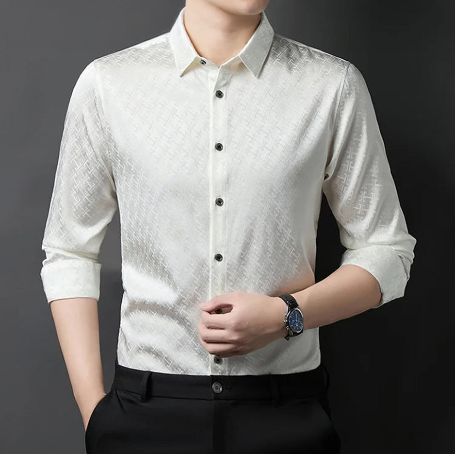 A man standing with one hand in his pocket while adjusting the front of his premium ivory white Mulberry silk jacquard shirt — From Borcelleclothes.