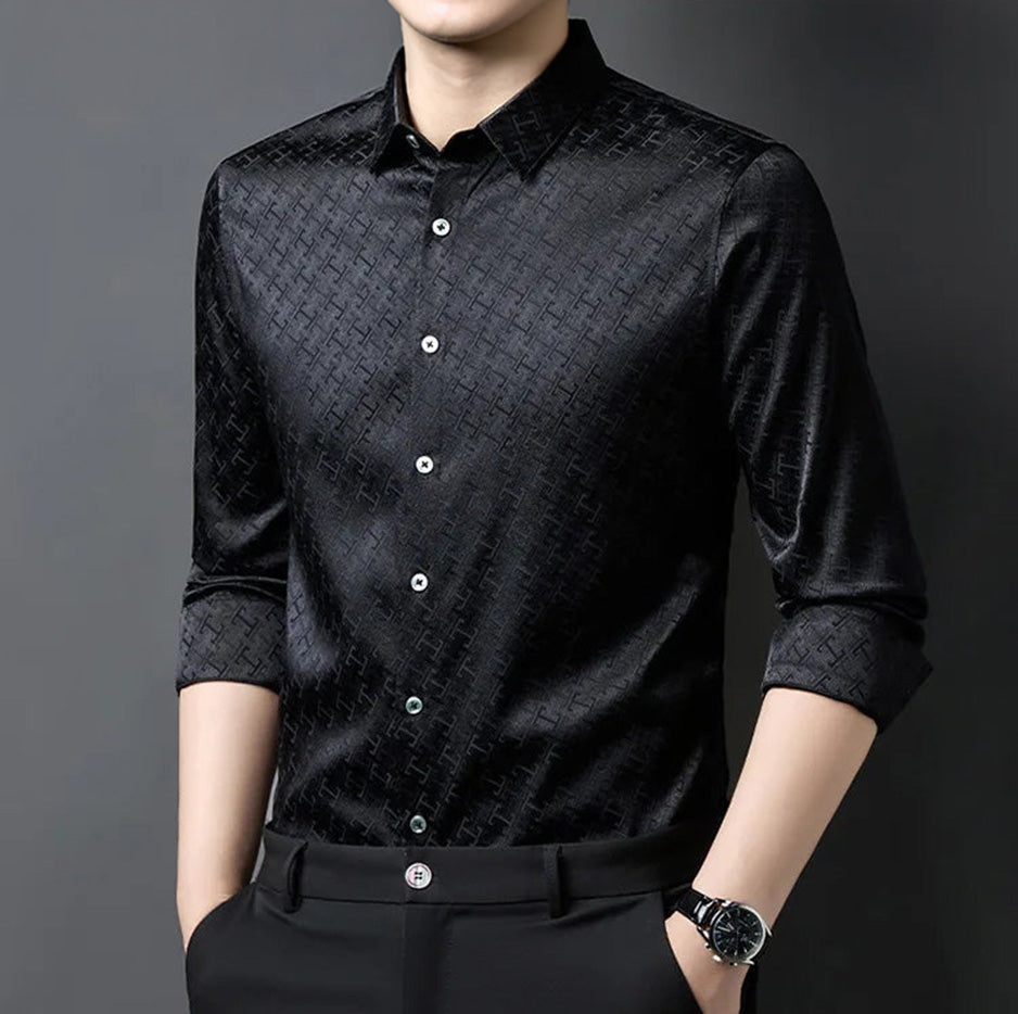A man capturing a powerful stance in the Night Matrix black Mulberry silk shirt, tailored with a geometric jacquard texture — From Borcelleclothes.