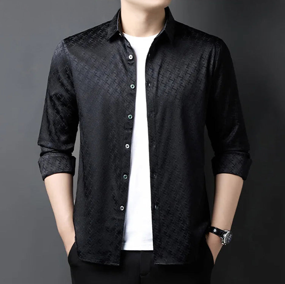 A man wearing the black unbuttoned silk shirt for a relaxed yet commanding look, hands in pockets — From Borcelleclothes.
