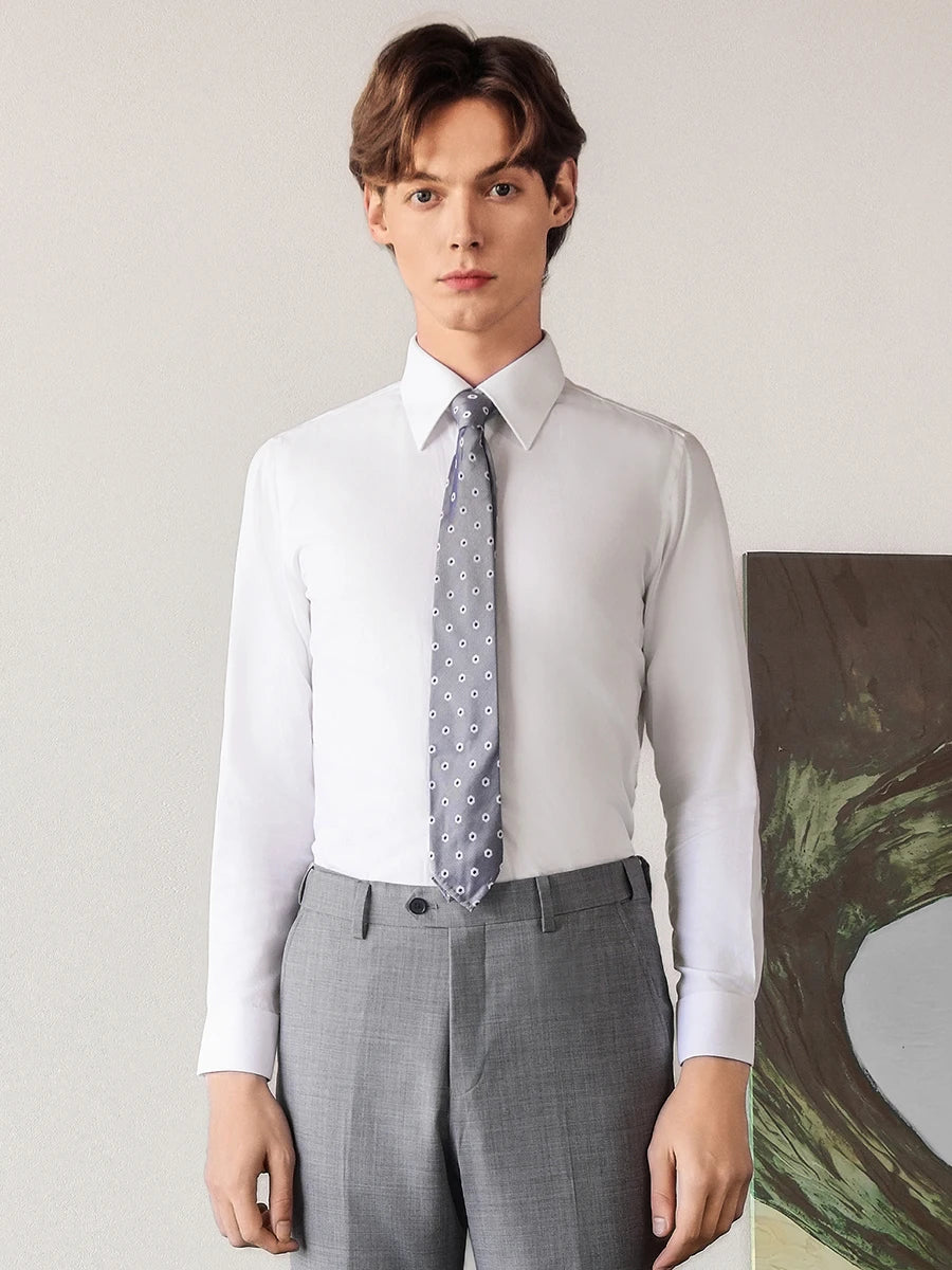 Men's premium cotton-silk shirt in Lotus White, with the model standing straight, arms along his legs, displaying the perfect geometric proportions of the shirt. — From Borcelleclothes.