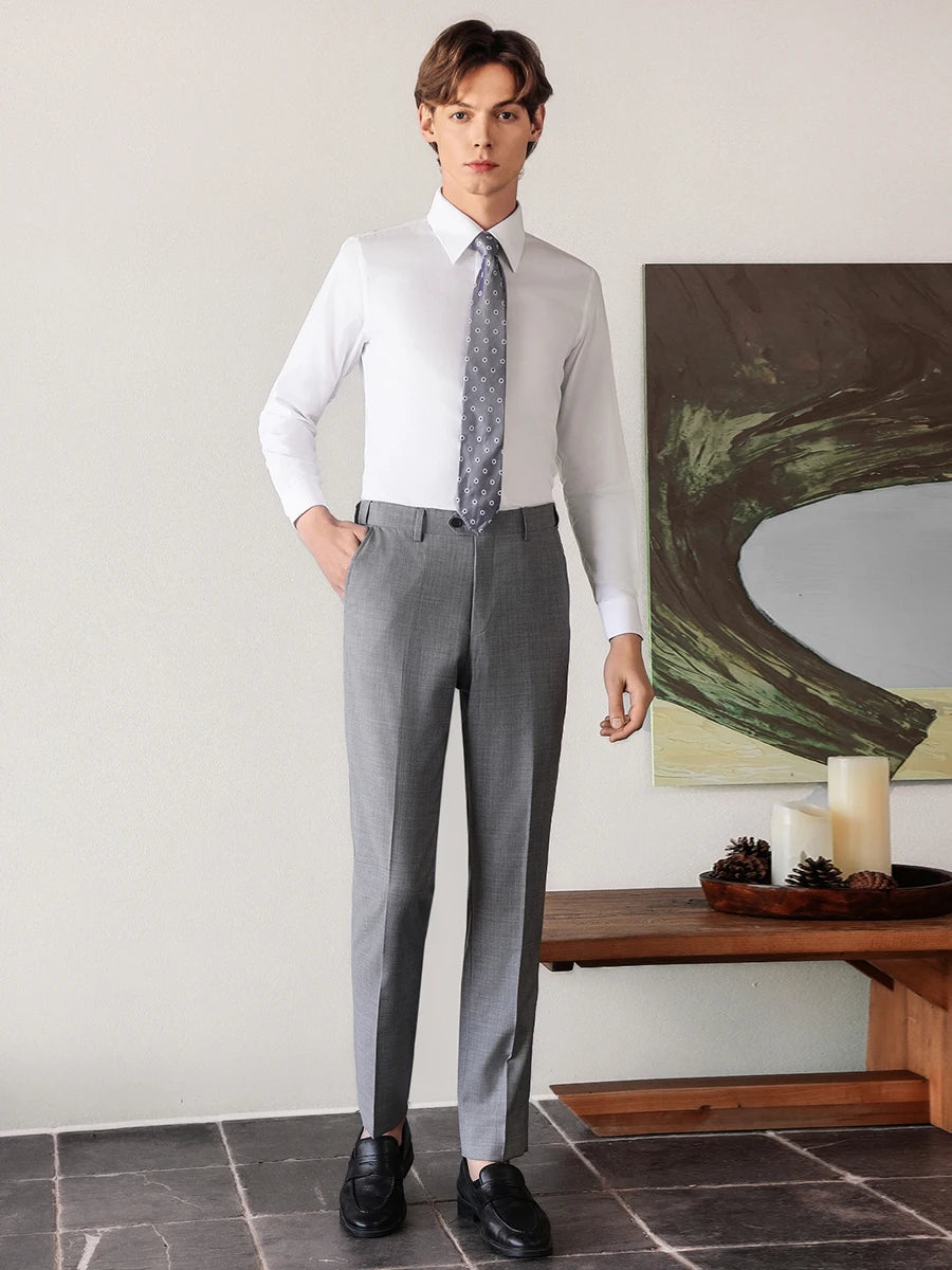 Sophisticated man in a Lotus White cotton-silk shirt stepping forward with a hand in his trousers pocket, showing dynamic ease and flawless fit. — From Borcelleclothes.