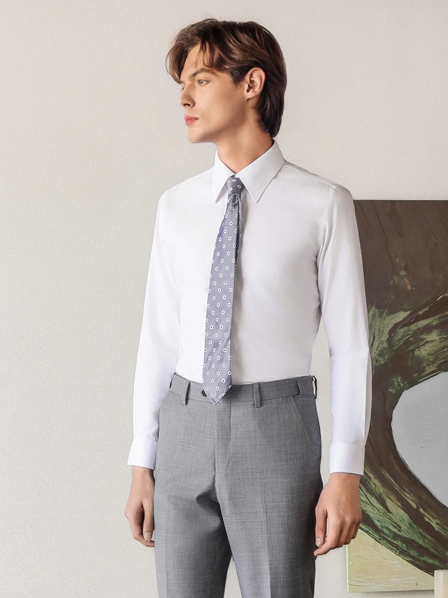 Men's luxury cotton-silk shirt in Lotus White, with the model turned slightly to the side, showcasing the sharp silhouette and premium 87% cotton and 13% Mulberry silk drape. — From Borcelleclothes.