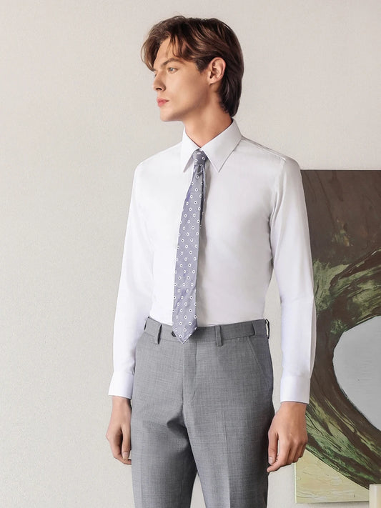 Men's luxury cotton-silk shirt in Lotus White, with the model turned slightly to the side, showcasing the sharp silhouette and premium 87% cotton and 13% Mulberry silk drape. — From Borcelleclothes.