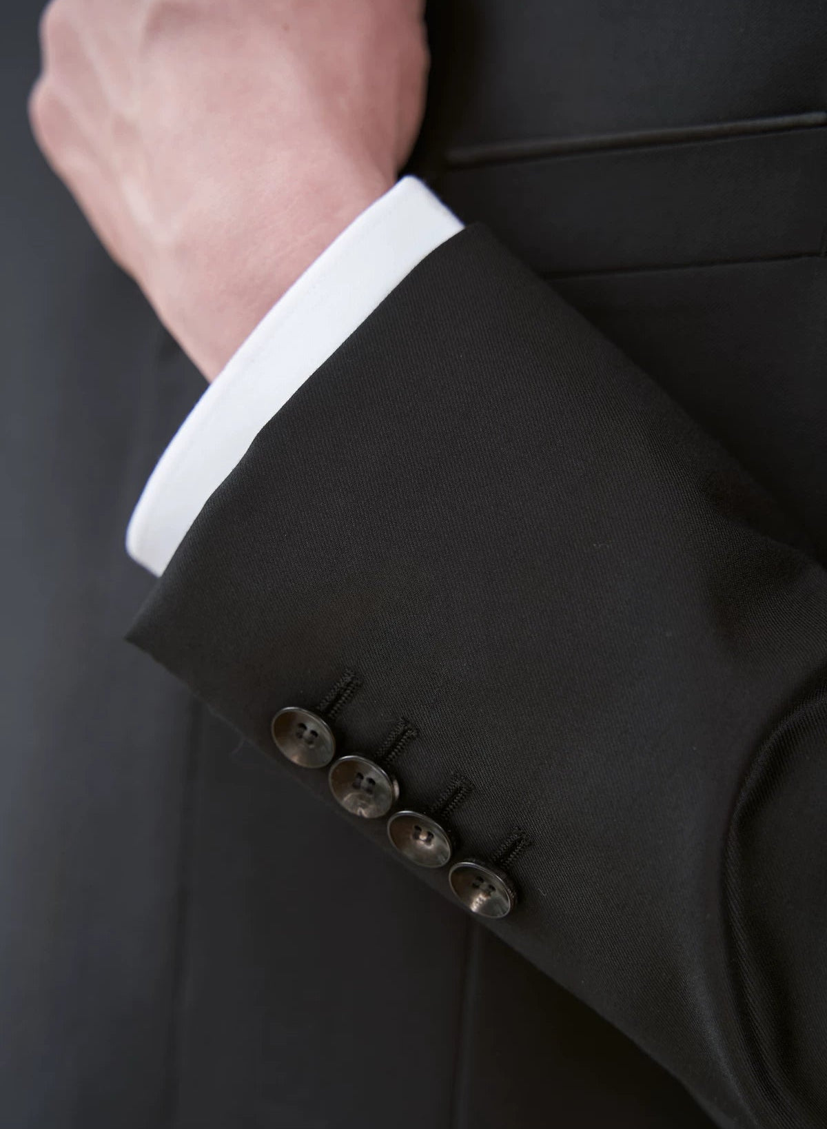 Close-up of functional four-button surgeon's cuffs on the At the Abyss merino wool jacket sleeve — From Borcelleclothes.