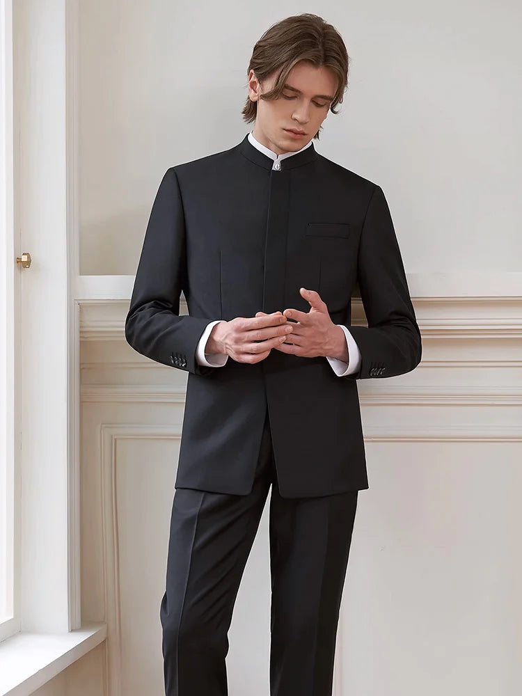 Model in At the Abyss stand-collar wool suit touching fingertips, highlighting the fly front silhouette and tailored fit — From Borcelleclothes.