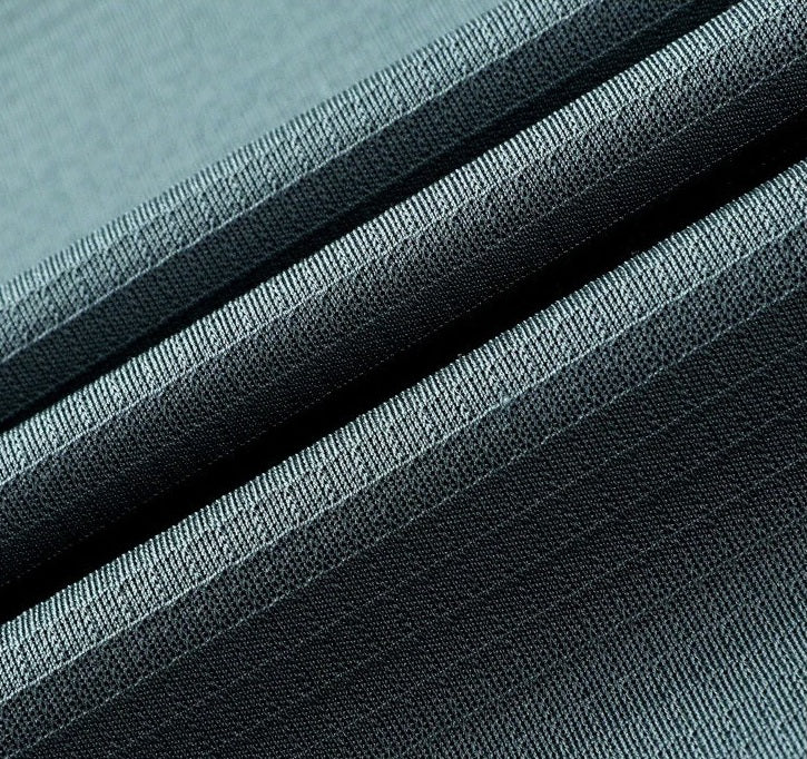 Waved fold detail of the Bermuda Grey 220g Mulberry silk fabric, highlighting its fluid drape and matte ribbed luster — From Borcelleclothes.