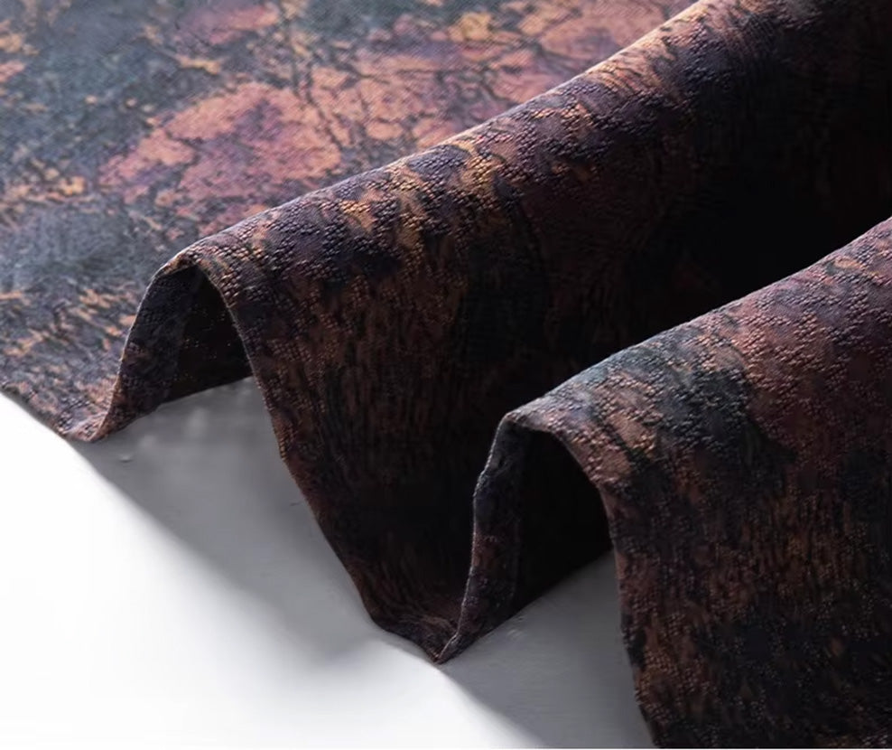 Close-up of the clean, finished bottom hem line on the mottled luxury Xiangyunsha jacquard silk shirt — From Borcelleclothes.