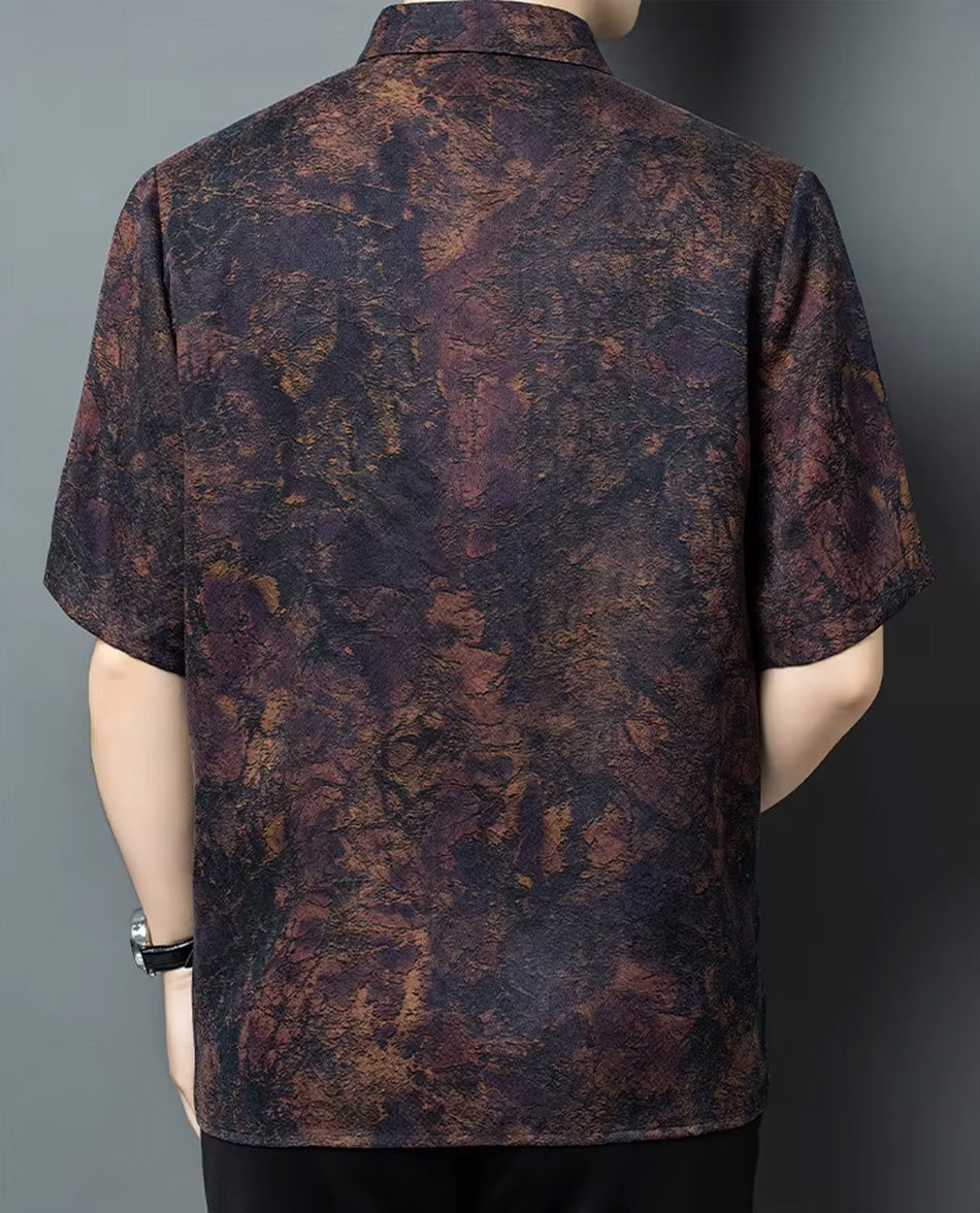 Back view of a man wearing the mottled Trail of Emotions Xiangyunsha silk shirt, highlighting the seamless pattern flow — From Borcelleclothes.