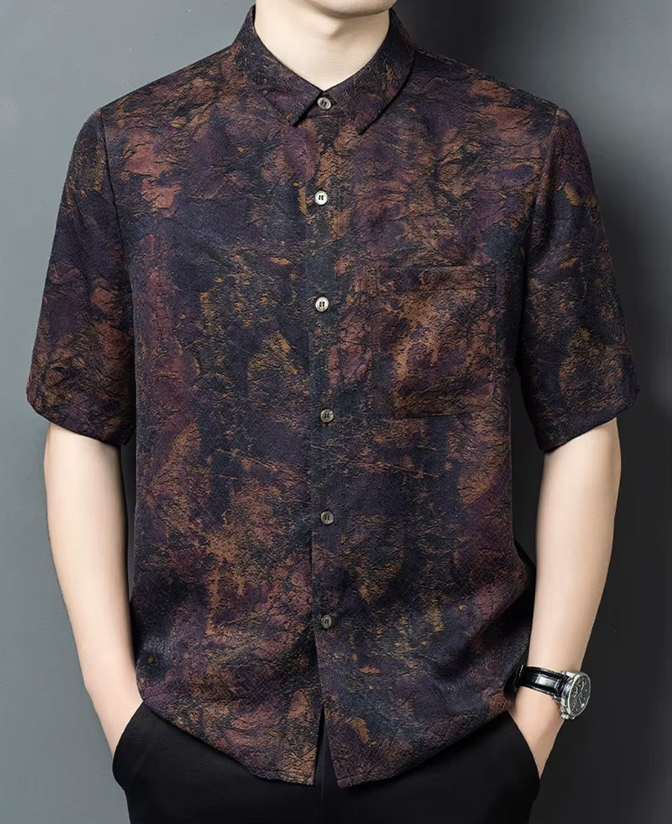 Front view of a man with his hands in his trousers pockets, showcasing the drape of the mottled Xiangyunsha jacquard silk shirt — From Borcelleclothes.