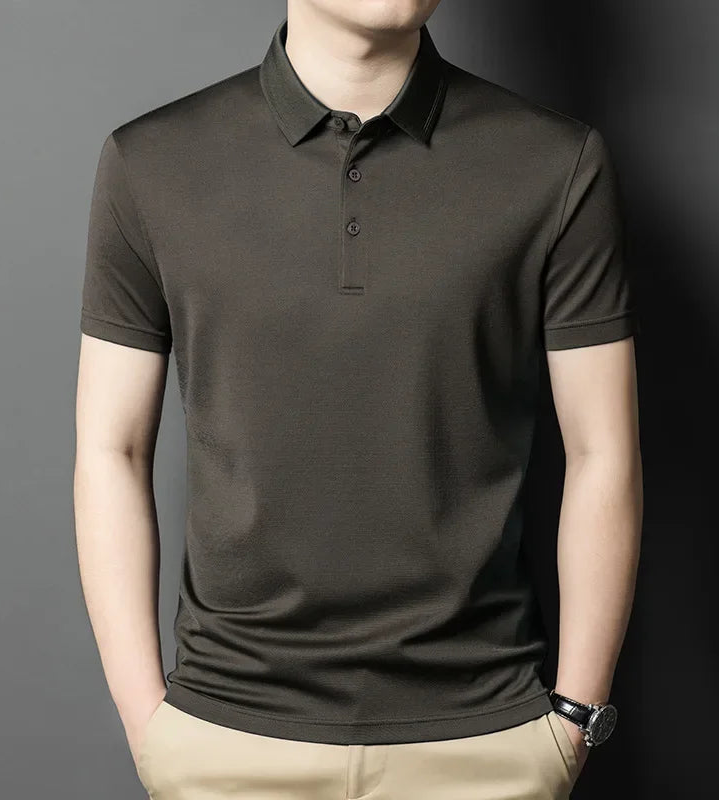 Model with hands in the pants pockets wearing a Men's Mulberry Silk Micro-Piqué Polo in Dragon's Breath featuring a twin-needle stitch pointed collar and mother-of-pearl buttons. — From Borcellelothes.