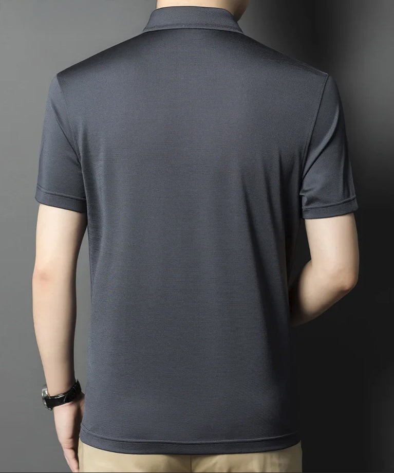 Back view of Tender Silk silk polo worn by a man; the shirt’s stillness and sheen suggest presence without effort. From Borcelleclothes.