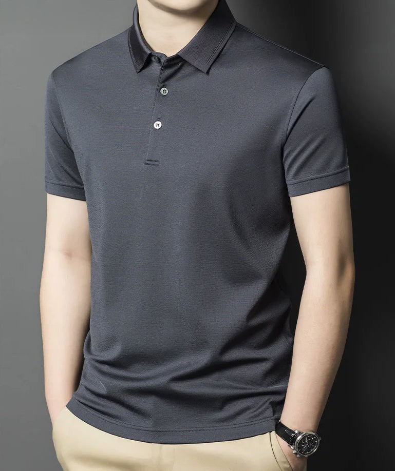 Tender Night Mulberry silk polo worn by a man standing in composed stillness; the collar’s tracework barely catches the light. From Borcelleclothes.