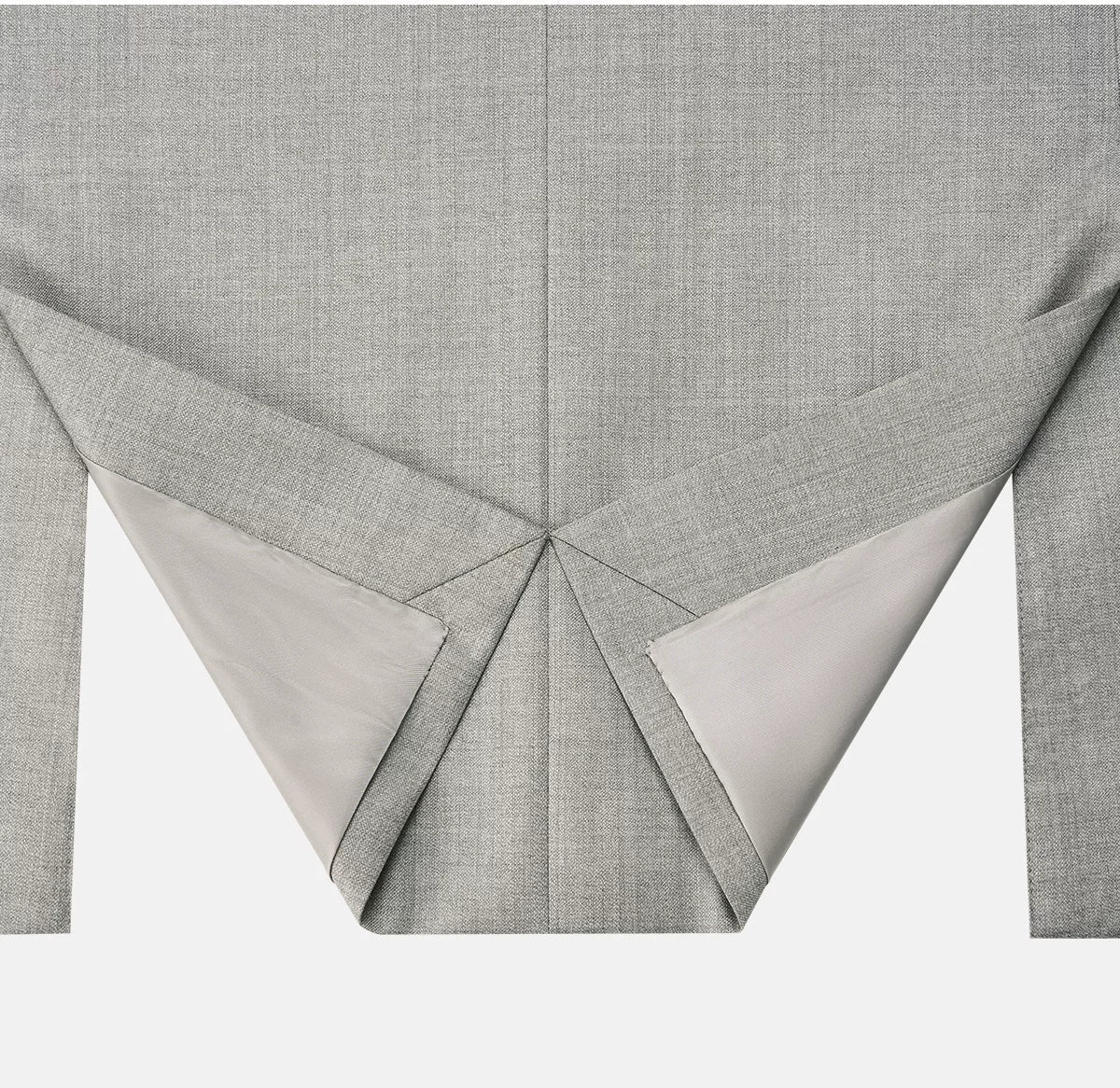 Back hem detail of Neapolitan jacket showing clean folded side vents — From Borcelleclothes.