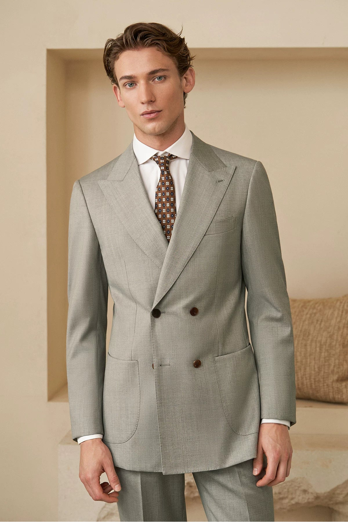 Dynamic silhouette view of model in Neapolitan cut VBC wool suit in olive-tinted gray — From Borcelleclothes.